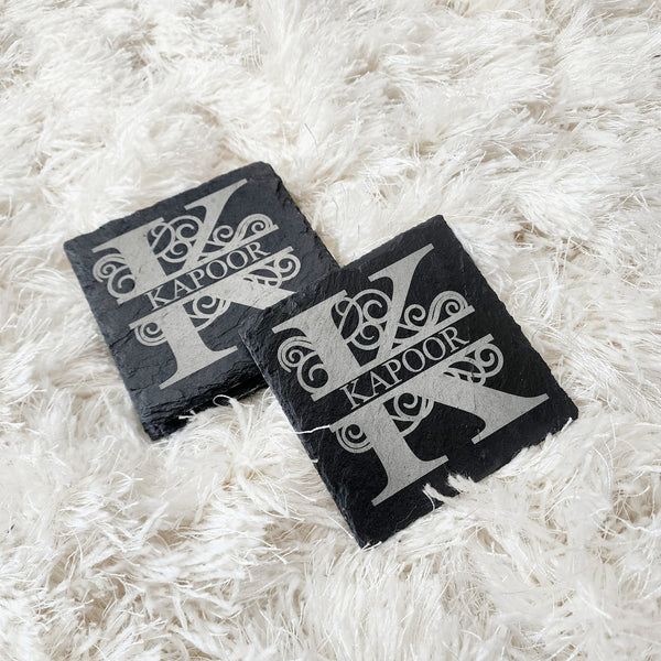 Monogrammed engraved coasters with your initial and last name on it. Beautiful, hand-shaped coasters of natural slate show off their uniquely chiseled edges, providing an earthy and naturally stain-resistant resting place for glasses.