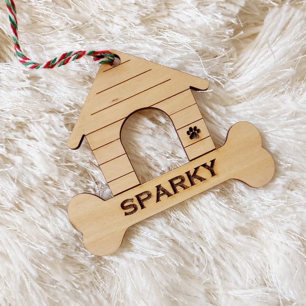 Christmas Ornament made in the style of dog house. Engraved with the name of your favorite four-legged friend and a paw print. Makes a great gift for all pet lovers.
