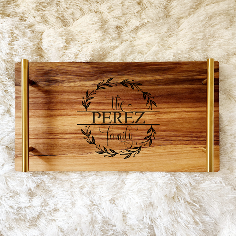 Wooden tray made of acacia wood with handles. The handles are bronze/brass finish. The tray is engraved with a design with the words The Perez family. The name is customized as per your request.