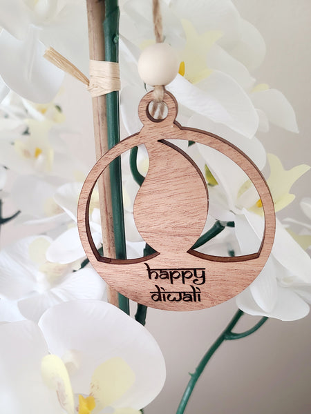 Diwali Diya or Lamp ornament made of wood. Engraved with the words Happy Diwali. Home decor for Indian South Asian home during the hindu festival of Diwali or Deepavali - Festival of Lights. Can also be used as a gift tag. Personalization options available.